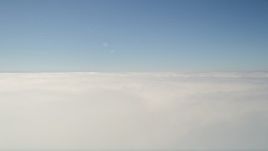 5K aerial stock footage pan across dense cloud cover with blue skies overhead, California Aerial Stock Footage | AX0016_003