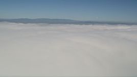 5K aerial stock footage pan across a thick layer of clouds with blue skies overhead, California Aerial Stock Footage | AX0016_005