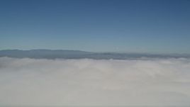 5K aerial stock footage of panning across dense cloud cover over California Aerial Stock Footage | AX0016_006