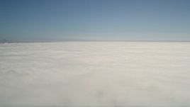 5K aerial stock footage pan across the cloud layer beneath blue skies, California Aerial Stock Footage | AX0016_009