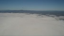 5K aerial stock footage pan across a layer of clouds to reveal the edge of the layer, California Aerial Stock Footage | AX0016_010