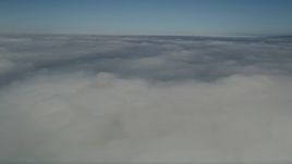 5K aerial stock footage fly by and pan across a layer of clouds over California Aerial Stock Footage | AX0016_017