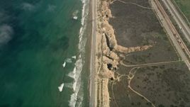 5K aerial stock footage of a bird's eye view of coastal cliffs and empty beach in Oceanside, California Aerial Stock Footage | AX0016_029
