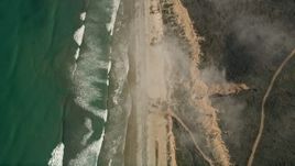 5K aerial stock footage of a bird's eye of ocean waves rolling toward empty beach and cliffs, Oceanside, California Aerial Stock Footage | AX0016_030E