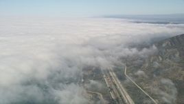 5K aerial stock footage tilt from empty beach and I-5 to reveal heavy cloud cover, Oceanside, California Aerial Stock Footage | AX0016_032