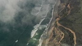 5K aerial stock footage of a bird's eye of ocean waves rolling toward a beach and cliffs, Oceanside, California Aerial Stock Footage | AX0016_033E