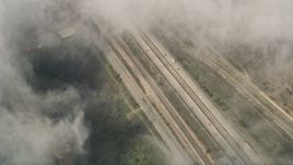 5K aerial stock footage of a bird's eye of light traffic on Interstate 5 through dense clouds, Oceanside, California Aerial Stock Footage | AX0016_035