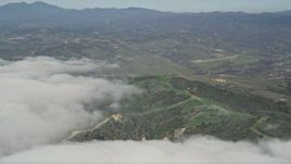 5K aerial stock footage of clouds by a military base training camp, Camp Pendleton, California Aerial Stock Footage | AX0016_036
