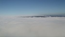 5K aerial stock footage fly over and pan across a cloud layer with blue skies above, Laguna Niguel, California Aerial Stock Footage | AX0016_048
