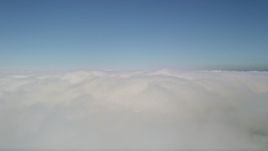 5K aerial stock footage pan across a layer of clouds with blue skies overhead, California Aerial Stock Footage | AX0016_051