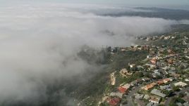 5K aerial stock footage tilt and fly over upscale, hillside homes and a fog bank in Laguna Niguel, California Aerial Stock Footage | AX0016_059