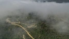 5K aerial stock footage tilt from fog over the hills to reveal and approach hilltop homes, Laguna Beach, California Aerial Stock Footage | AX0016_066