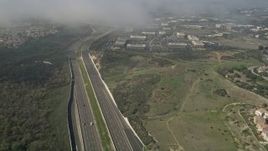 5K aerial stock footage flyby light traffic on Highway 73 near homes and office buildings Irvine, California Aerial Stock Footage | AX0016_077