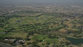 5K aerial stock footage of approaching Mile Square Regional Park and golf course, Fountain Valley, California Aerial Stock Footage | AX0016_092E