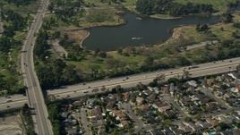5K aerial stock footage of track light traffic on I-605 by Long Beach Town Center and El Dorado East Regional Park, Long Beach, California Aerial Stock Footage | AX0016_103E