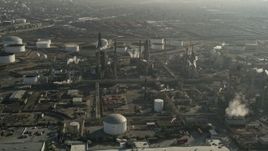 5K aerial stock footage of flying by an oil refinery and smoke stacks, Carson, California Aerial Stock Footage | AX0017_005