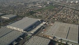 5K aerial stock footage fly over warehouses toward a residential neighborhood, Carson, California Aerial Stock Footage | AX0017_007