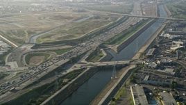5K aerial stock footage fly over heavy interstate traffic along a river, Carson, California Aerial Stock Footage | AX0017_010