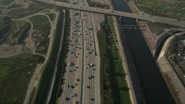 5K aerial stock footage of following heavy interstate traffic along the river, Carson, California Aerial Stock Footage | AX0017_024
