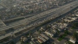 5K aerial stock footage of following Interstate 110 with heavy traffic through neighborhoods, Westmont, California Aerial Stock Footage | AX0017_034
