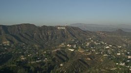 5K aerial stock footage of homes and apartment buildings in the hills, reveal Hollywood Sign, Hollywood, California Aerial Stock Footage | AX0017_086