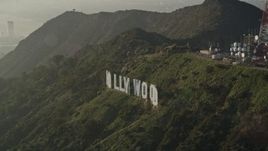 5K aerial stock footage of orbiting the Hollywood Sign in haze, Hollywood, California Aerial Stock Footage | AX0017_093