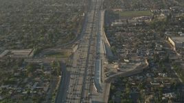 5K aerial stock footage of following heavy interstate traffic through neighborhoods, Pacoima, California, sunset Aerial Stock Footage | AX0017_117