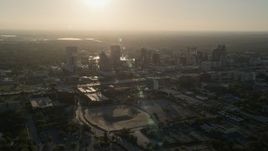 5K aerial stock footage orbit Downtown Orlando with rising sun in the distance in Florida Aerial Stock Footage | AX0018_010