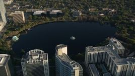 5K aerial stock footage tilt and approach Lake Eola in Downtown Orlando at sunrise in Florida Aerial Stock Footage | AX0018_020