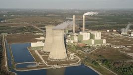 5K aerial stock footage of flying by Stanton Energy Center, a power plant in Orlando at sunrise in Florida Aerial Stock Footage | AX0018_031