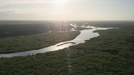 5K aerial stock footage of a slow approach to St. Johns River near Orlando at sunrise, Florida Aerial Stock Footage | AX0018_040E