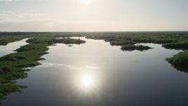 5K aerial stock footage of flying low over St. Johns River near Orlando, Florida at sunrise Aerial Stock Footage | AX0018_045E
