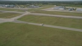 5K aerial stock footage approach small airplane at St. Lucie County International Airport in Florida Aerial Stock Footage | AX0018_101