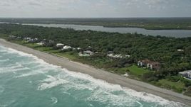 5K aerial stock footage tilt to reveal beachfront mansions in Hobe Sound, Florida Aerial Stock Footage | AX0019_026E