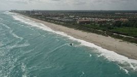 5K aerial stock footage approach kite surfer by the beach in Jupiter, Florida Aerial Stock Footage | AX0019_041E