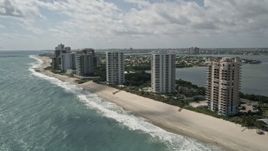 5K aerial stock footage of passing beachfront condominium complexes in Riviera Beach, Florida Aerial Stock Footage | AX0019_045E