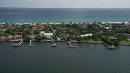 5K aerial stock footage of lakefront mansions with docks in Palm Beach, Florida Aerial Stock Footage | AX0019_066