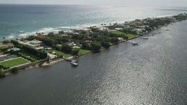 5K aerial stock footage of passing waterfront mansions with docks on Lake Worth in Palm Beach, Florida Aerial Stock Footage | AX0019_069E