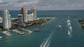 5K aerial stock footage fly over ferries on Government Cut and tilt to reveal South Beach skyscrapers in Florida Aerial Stock Footage | AX0020_040