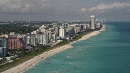 5K aerial stock footage tilt from the ocean to reveal beachfront condos in Miami Beach, Florida Aerial Stock Footage | AX0020_056E