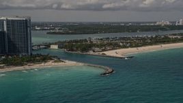 5K aerial stock footage flyby oceanfront buildings to approach an inlet in Bal Harbour, Florida Aerial Stock Footage | AX0020_070E