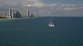 5K aerial stock footage approach a yacht racing across calm ocean near Sunny Isles Beach, Florida Aerial Stock Footage | AX0020_072