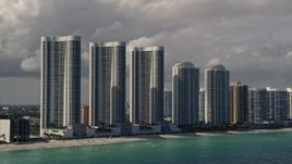 5K aerial stock footage of Trump Towers skyscrapers on the shore of Sunny Isles Beach, Florida Aerial Stock Footage | AX0020_074