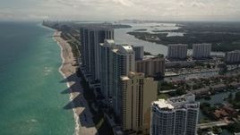 5K aerial stock footage fly over beach and pier by oceanfront hotel and high-rises in Sunny Isles Beach, Florida Aerial Stock Footage | AX0020_086E