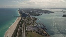 5K aerial stock footage fly over coastal road by the beach and tilt to reveal more coast through Bal Harbour, Florida Aerial Stock Footage | AX0020_089E