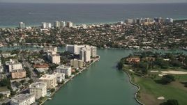5K aerial stock footage fly over waterfront homes, tilt to approach coastal community on Bay Harbor Islands, Florida Aerial Stock Footage | AX0021_013E