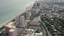 5K aerial stock footage tilt from Indian Creek to reveal condominiums by the beach in Miami Beach, Florida Aerial Stock Footage | AX0021_034