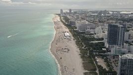 5K aerial stock footage fly over beach to approach hotels and condominiums with ocean views in Miami Beach, Florida Aerial Stock Footage | AX0021_035E