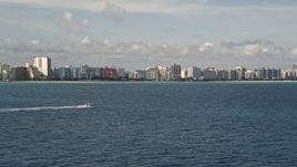5K aerial stock footage tracking a fishing boat sailing near the coast of Miami Beach, Florida Aerial Stock Footage | AX0021_045