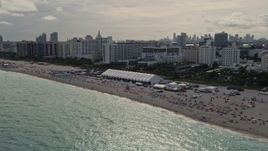 5K aerial stock footage of beachgoers and oceanfront hotels in Miami Beach, Florida Aerial Stock Footage | AX0021_052E